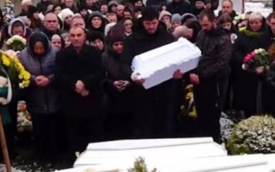 In the Photo … There is a Man Holding a Small White Coffin in His Arms. His Little Son is There. He is 1 Year Old. And next to it Are Two More Coffins: His Wife and Daughter – На фотографії… Чоловік тримає на руках маленьку білу труну. Його маленькому синові 1 рік. А поруч ще дві труни: його дружини та доньки.
